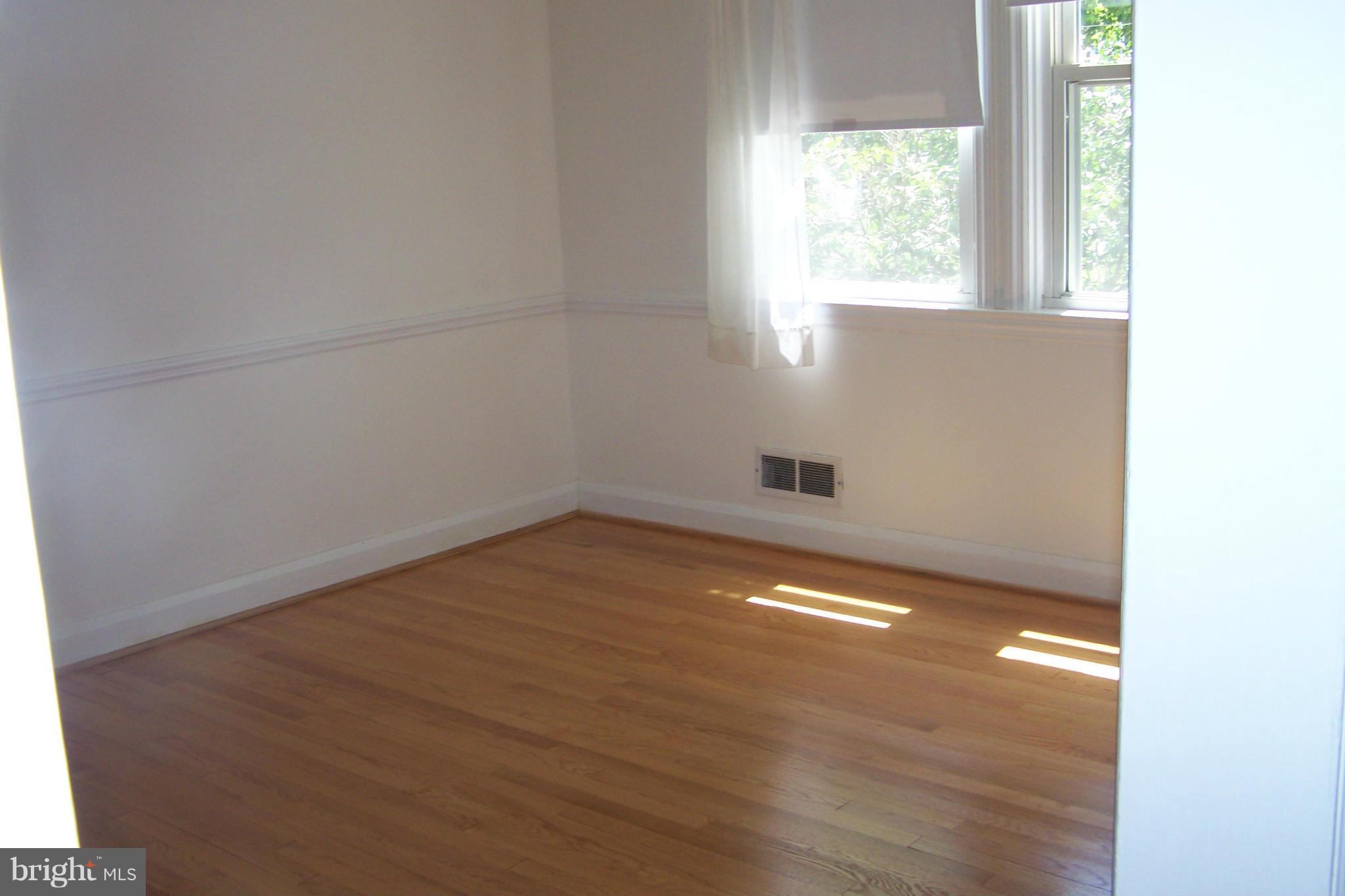 1111 Granville Road Baltimore, MD 21207 - Photo 14 of 19 a view of empty room with wooden floor and fan