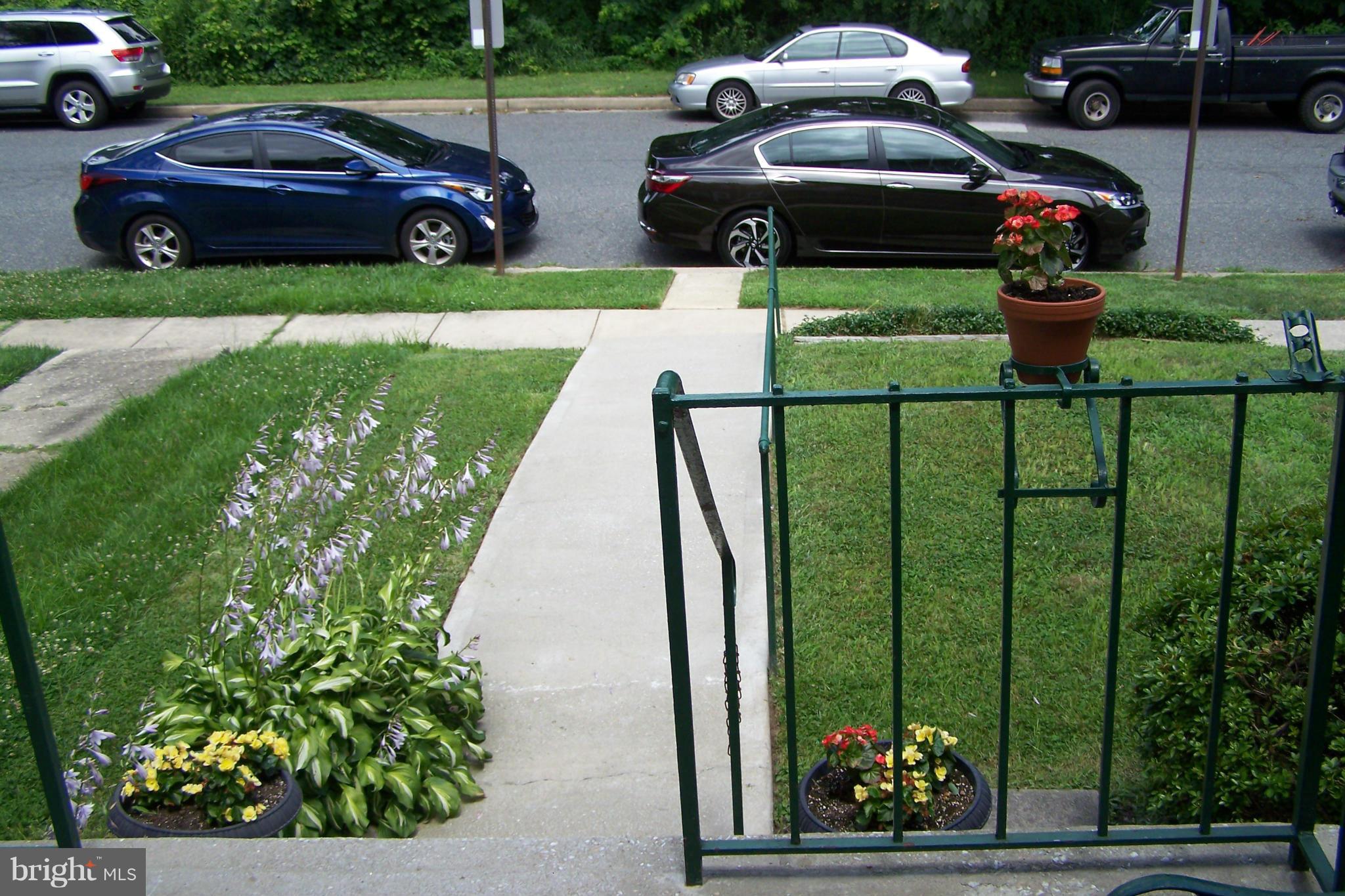 1111 Granville Road Baltimore, MD 21207 - Photo 5 of 19 a view of a garden with cars parked