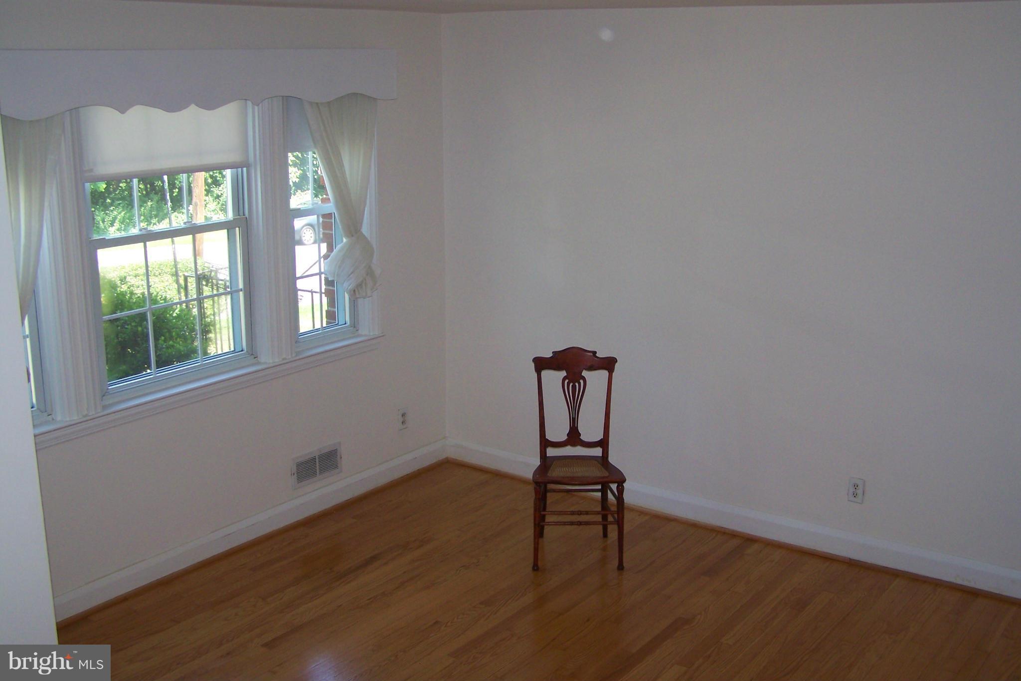 1111 Granville Road Baltimore, MD 21207 - Photo 7 of 19 an empty room with wooden floor and windows
