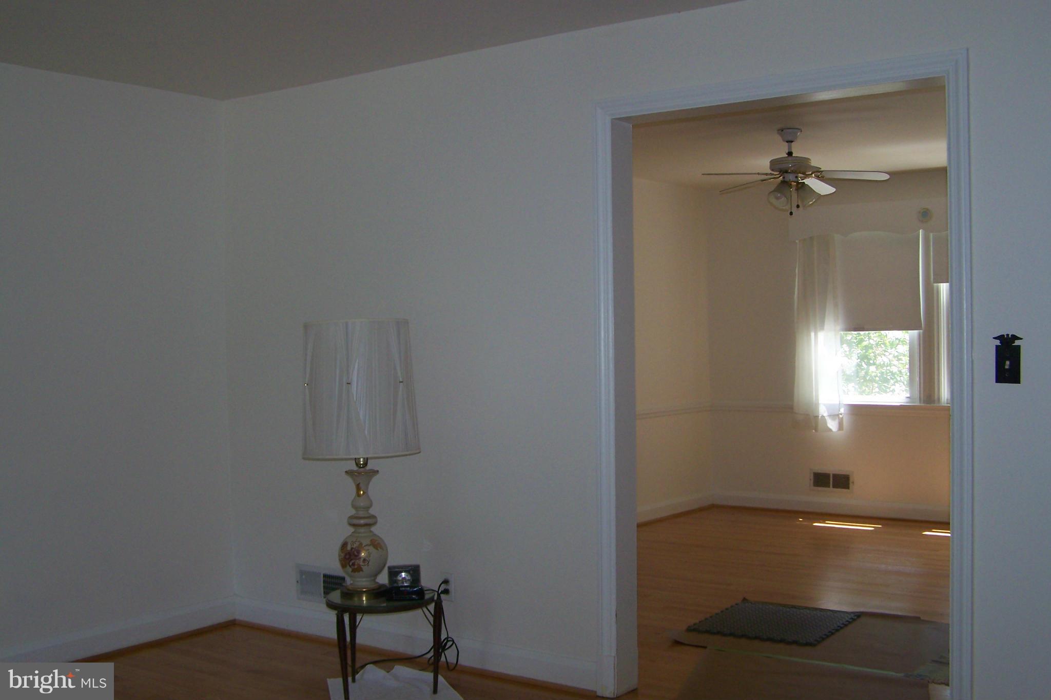 1111 Granville Road Baltimore, MD 21207 - Photo 8 of 19 an empty room with a window and a ceiling fan
