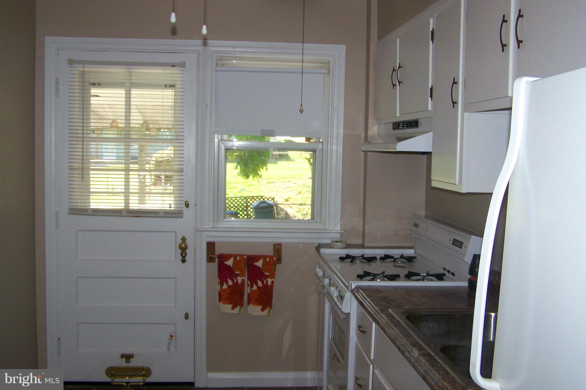 1111 Granville Road Baltimore, MD 21207 - Photo 9 of 19 a kitchen with a stove a refrigerator and a window