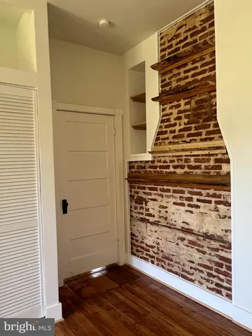 a sink with a window and wooden floor
