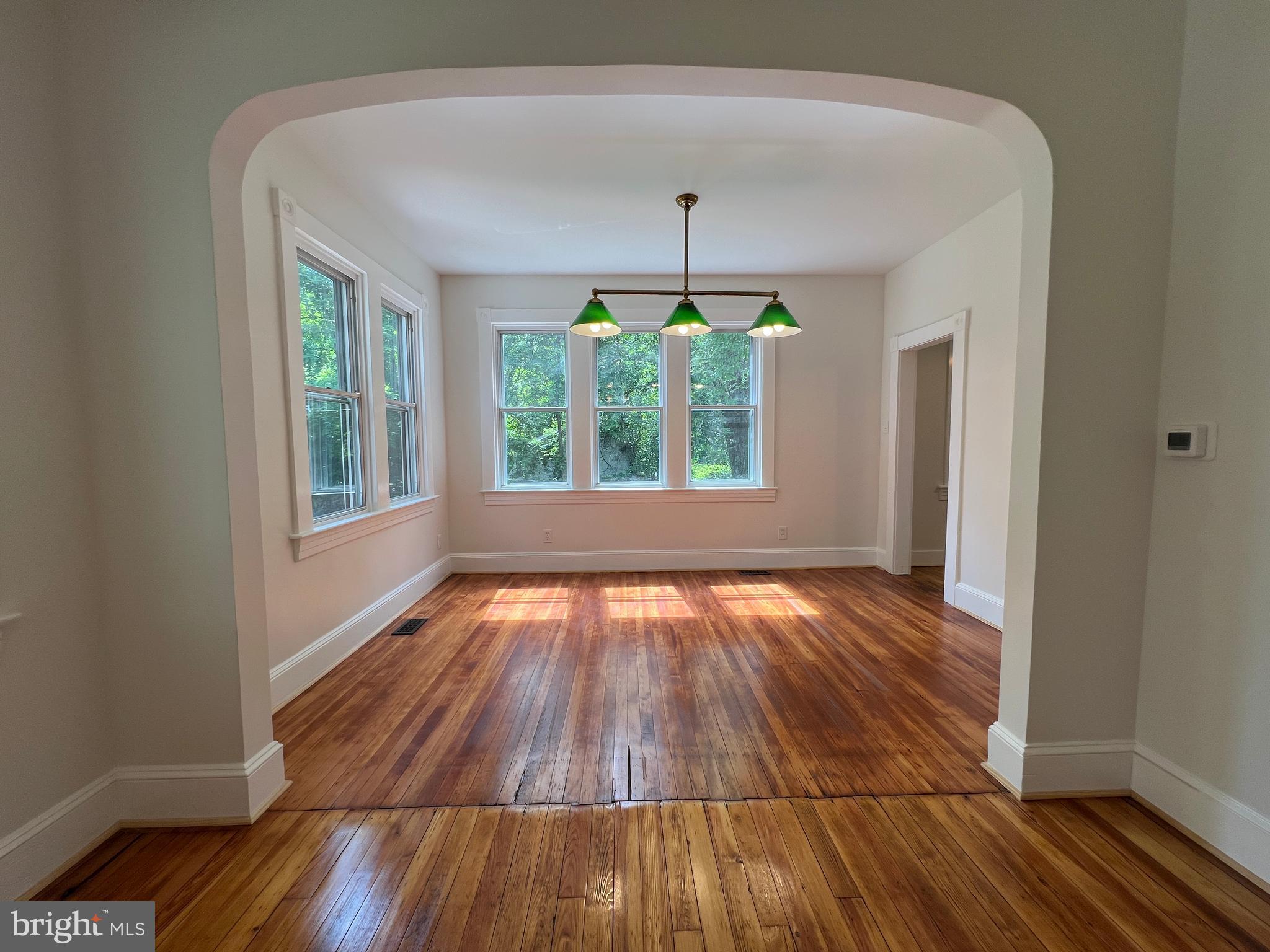 7308 Highbridge Road Bowie, MD 20720 - Photo 24 of 70 an empty room with wooden floor and windows