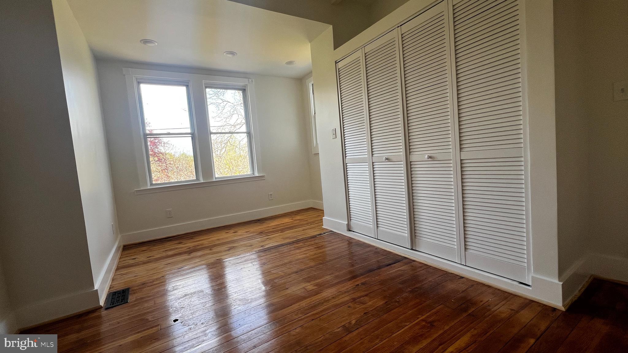 7308 Highbridge Road Bowie, MD 20720 - Photo 32 of 70 an empty room with wooden floor and windows