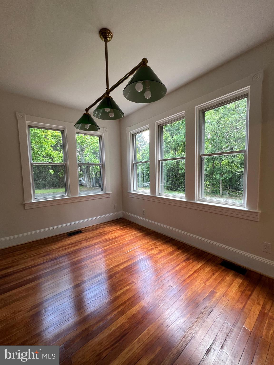 7308 Highbridge Road Bowie, MD 20720 - Photo 40 of 70 a view of an empty room with wooden floor and a window