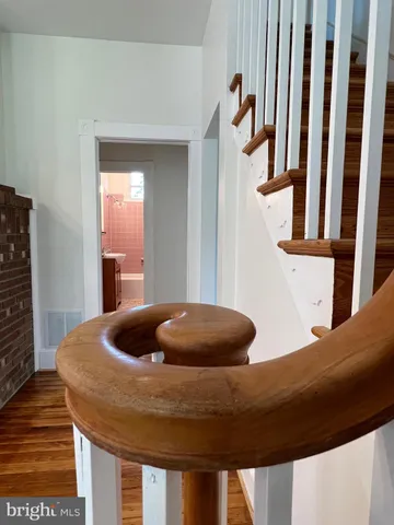 a view of a room with wooden floor and window