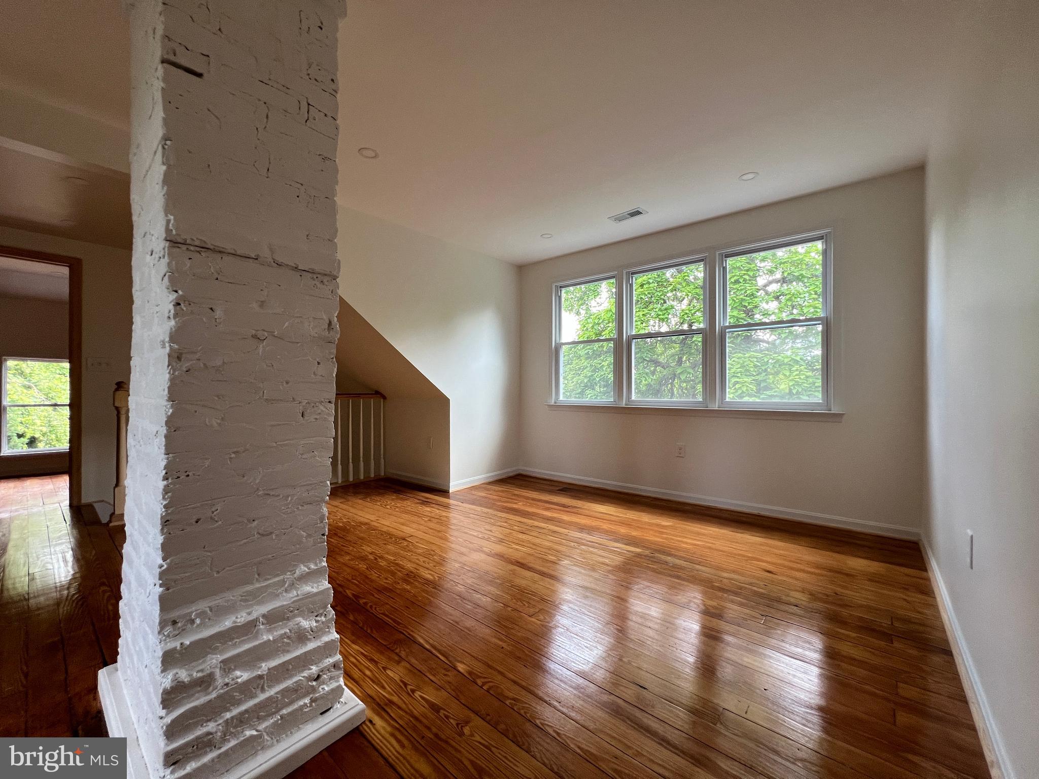 7308 Highbridge Road Bowie, MD 20720 - Photo 49 of 70 a view of an empty room with wooden floor and a window