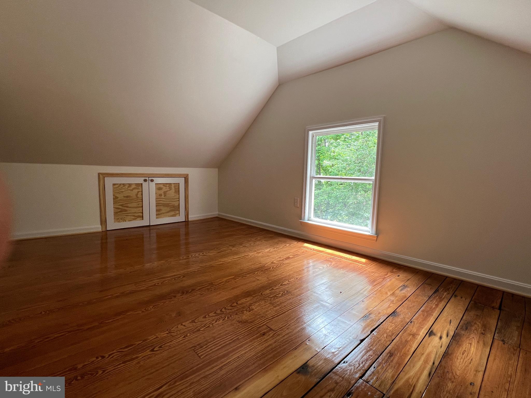 7308 Highbridge Road Bowie, MD 20720 - Photo 51 of 70 a view of an empty room with wooden floor and a window