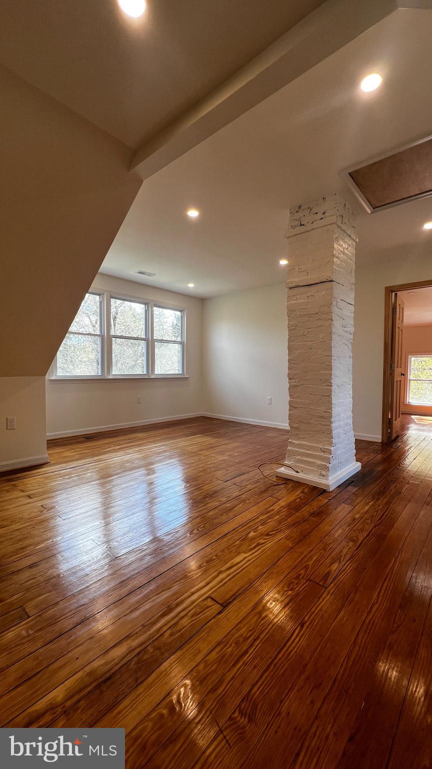 7308 Highbridge Road Bowie, MD 20720 - Photo 53 of 70 an empty room with wooden floor and windows