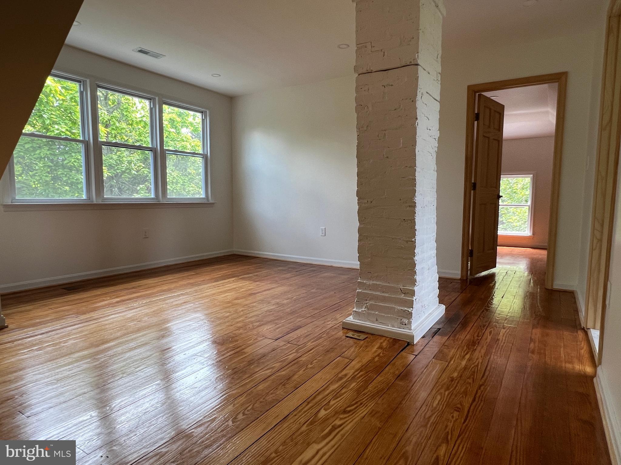7308 Highbridge Road Bowie, MD 20720 - Photo 54 of 70 an empty room with wooden floor and windows