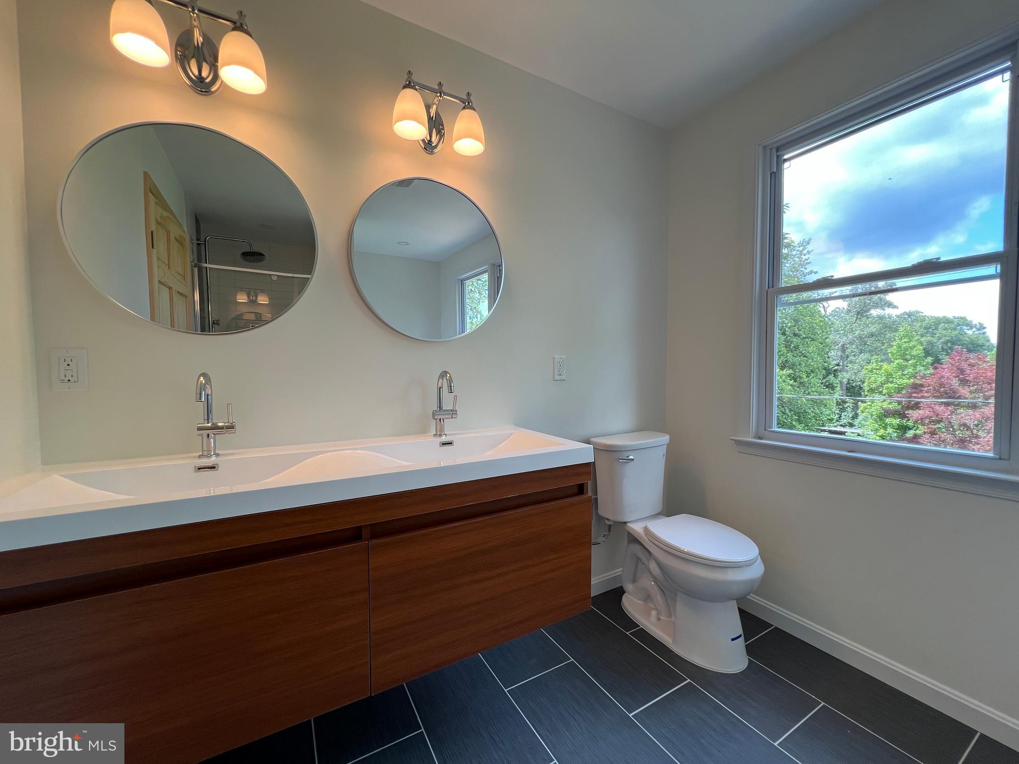 7308 Highbridge Road Bowie, MD 20720 - Photo 56 of 70 a bathroom with a toilet sink and mirror