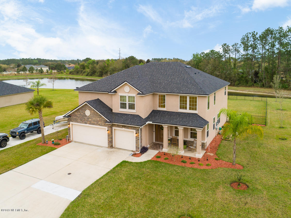 702 Irish Rose Road St. Augustine, FL 32092 - Photo 1 of 53 a front view of a house with a yard