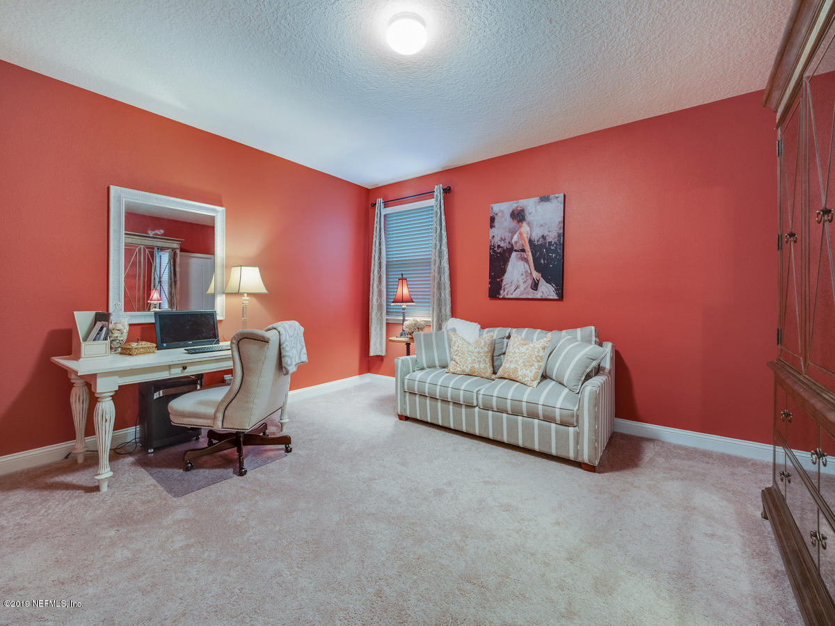 702 Irish Rose Road St. Augustine, FL 32092 - Photo 25 of 53 a living room with furniture and a window