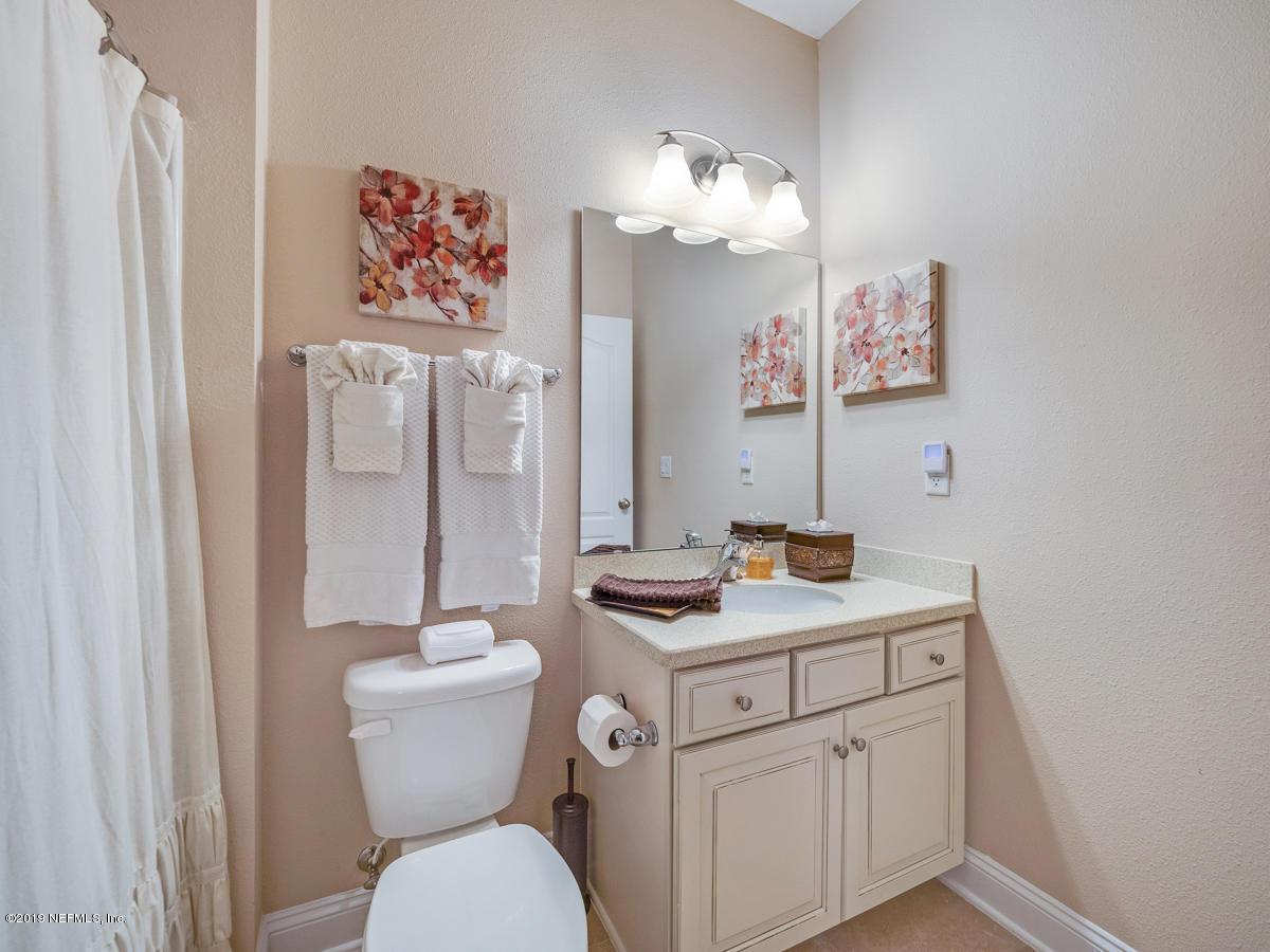 702 Irish Rose Road St. Augustine, FL 32092 - Photo 27 of 53 a bathroom with a granite countertop toilet sink and mirror