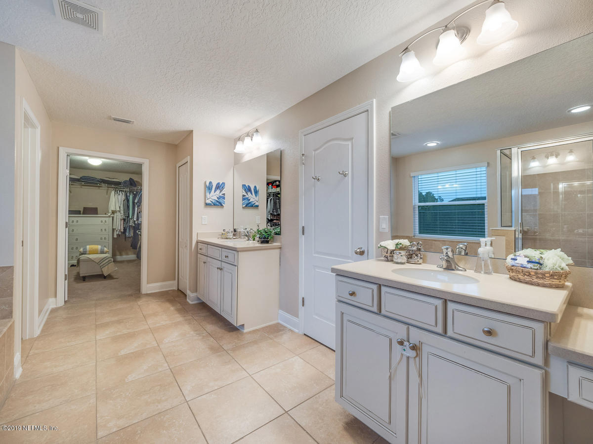 702 Irish Rose Road St. Augustine, FL 32092 - Photo 36 of 53 a bathroom with a sink vanity and mirror