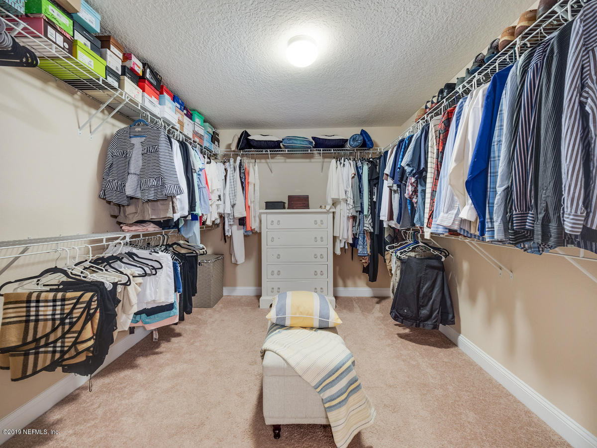702 Irish Rose Road St. Augustine, FL 32092 - Photo 40 of 53 a view of walk in closet with clothes and shoes