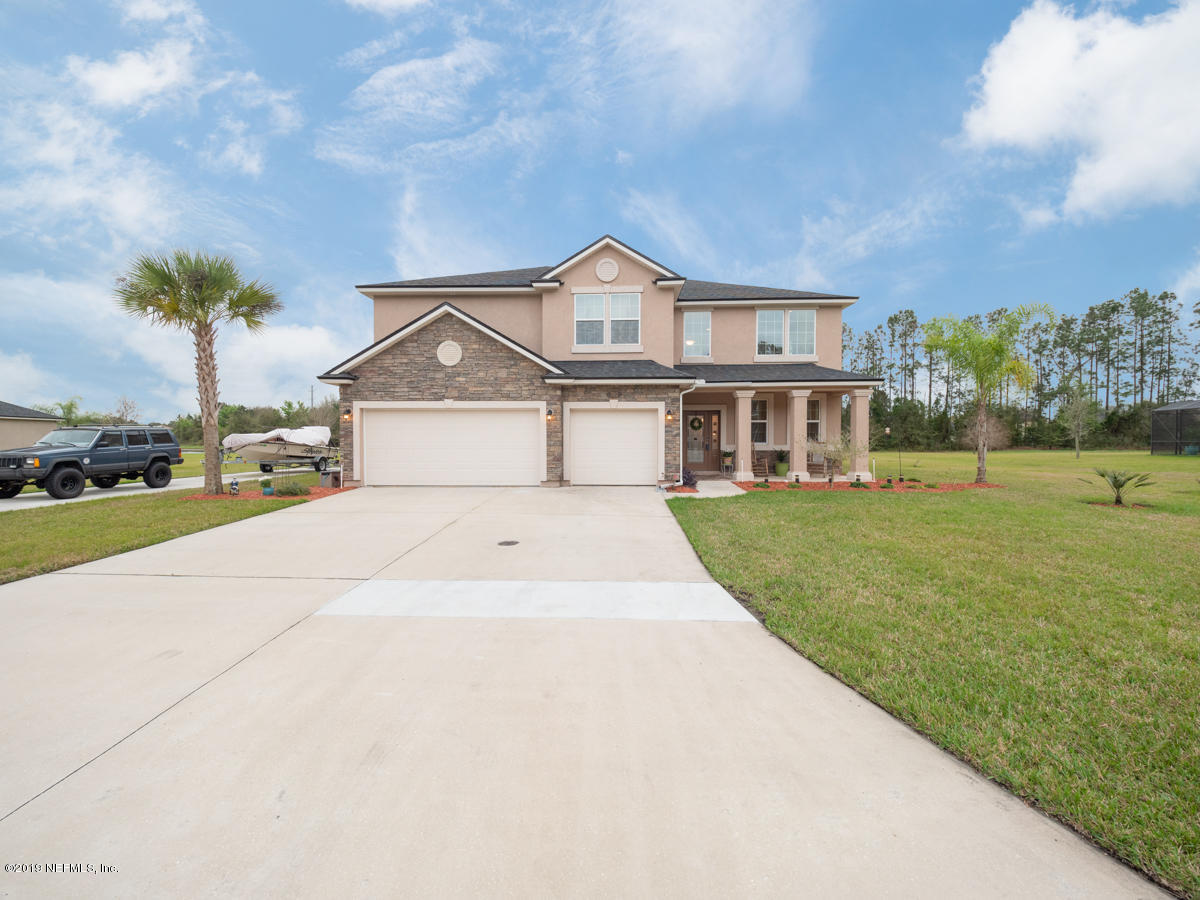 702 Irish Rose Road St. Augustine, FL 32092 - Photo 4 of 53 a front view of a house with a yard