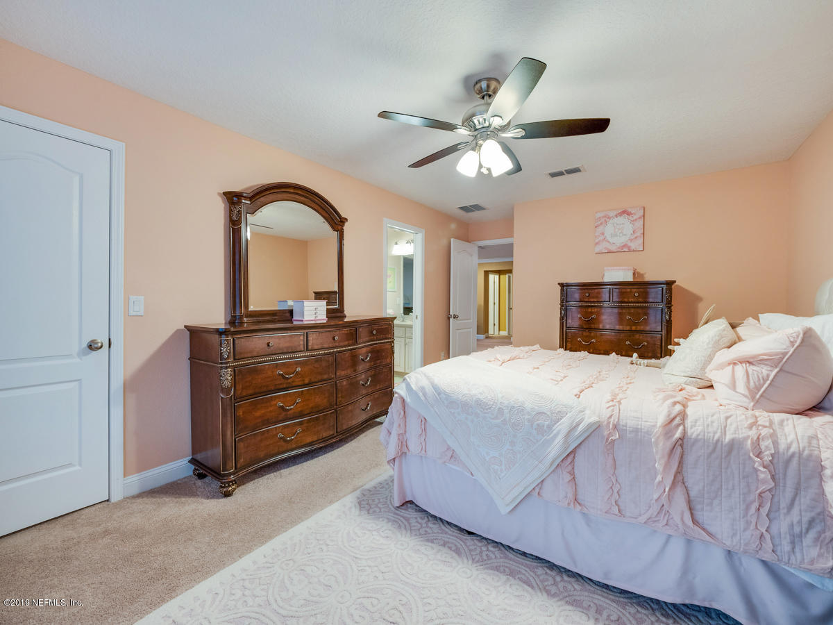 702 Irish Rose Road St. Augustine, FL 32092 - Photo 44 of 53 a bedroom with a bed and a dresser