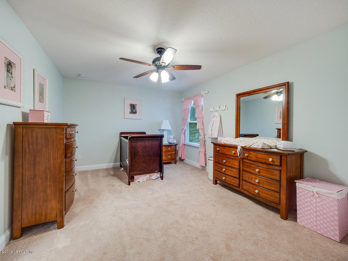 702 Irish Rose Road St. Augustine, FL 32092 - Photo 46 of 53 a living room with furniture and a flat screen tv