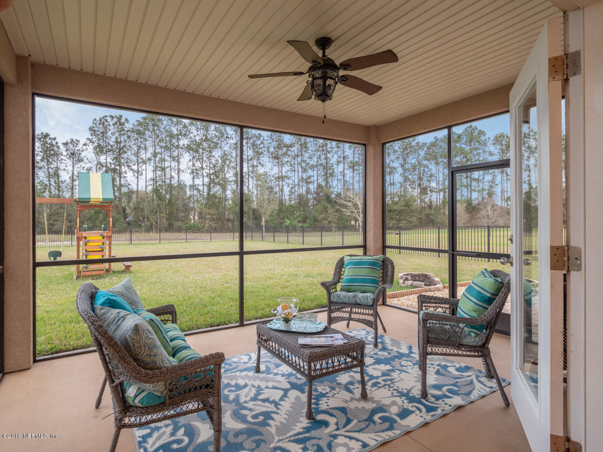 702 Irish Rose Road St. Augustine, FL 32092 - Photo 48 of 53 a living room with furniture and a large window