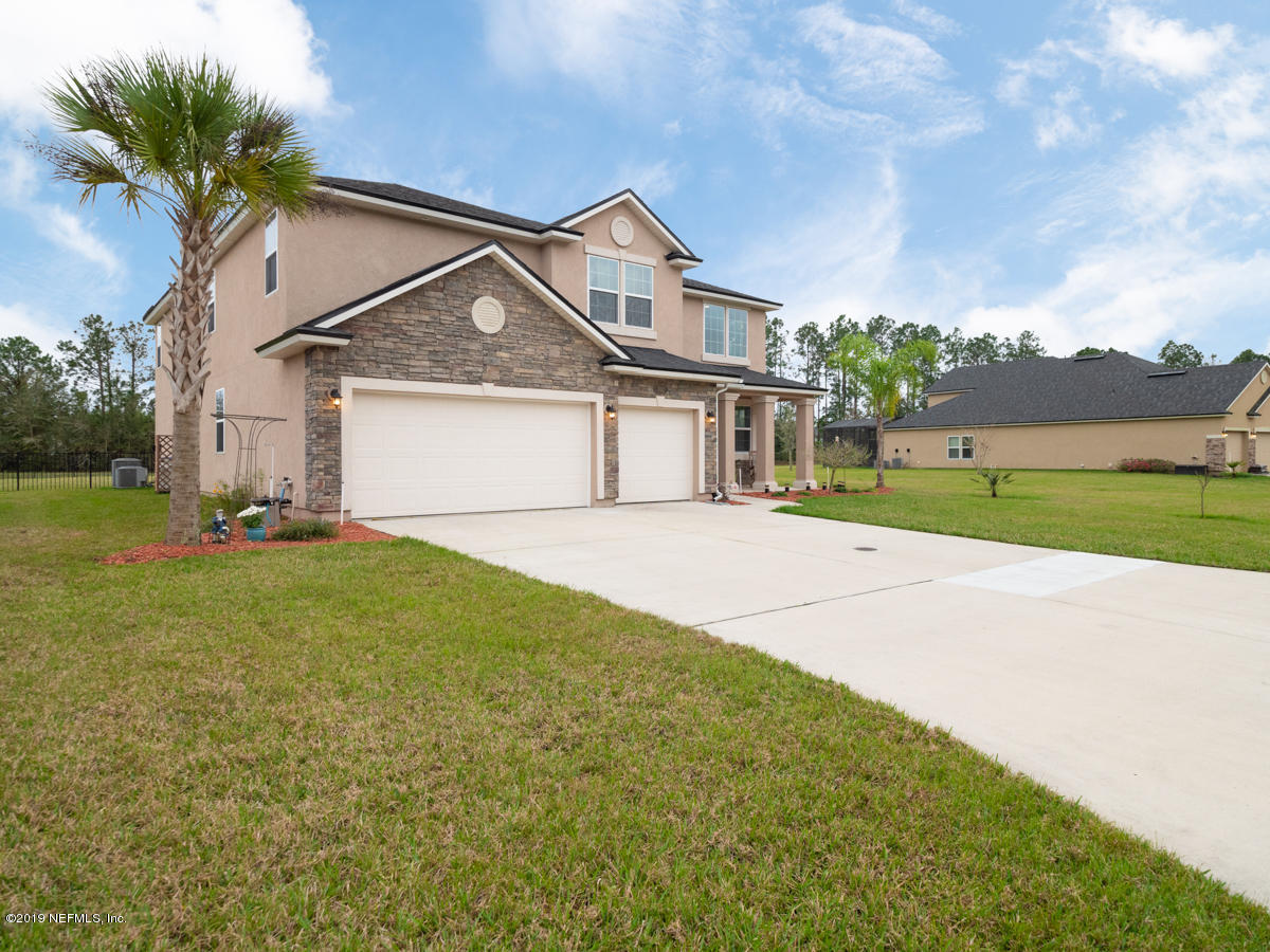 702 Irish Rose Road St. Augustine, FL 32092 - Photo 5 of 53 a front view of a house with a yard and garage