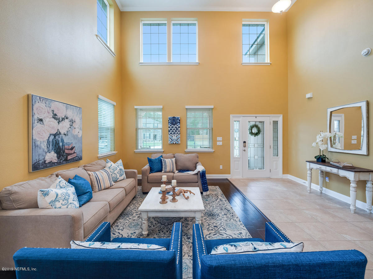 702 Irish Rose Road St. Augustine, FL 32092 - Photo 9 of 53 a living room with furniture and a couch
