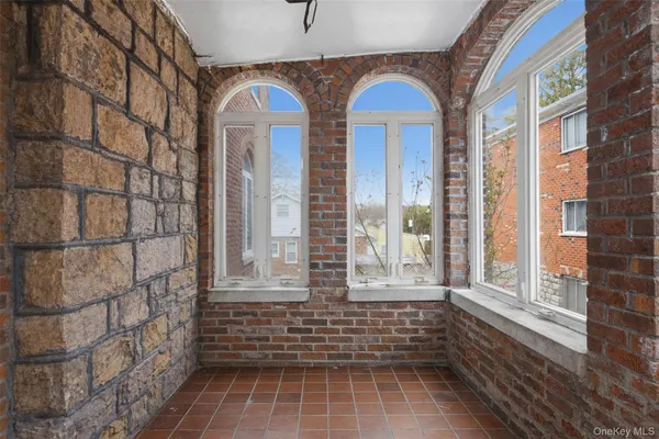 a view of a brick house with large windows