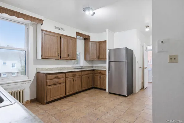a kitchen with sink cabinets and refrigerator