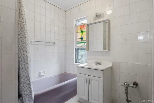 a bathroom with a bathtub a sink a vanity and a shower