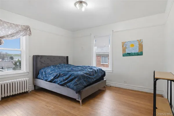 a bedroom with a bed and a painting on the wall