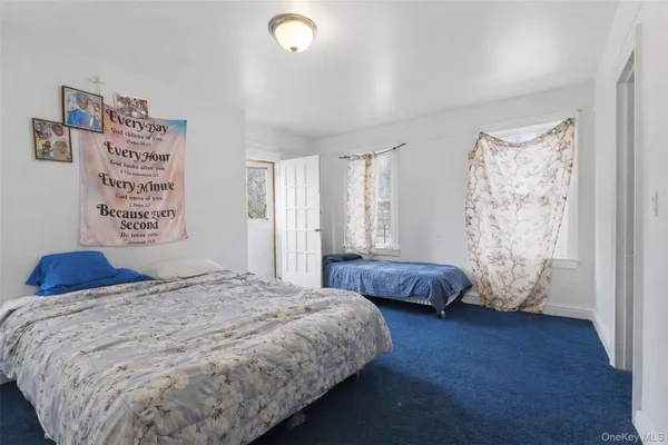 a bedroom with a large bed and a window