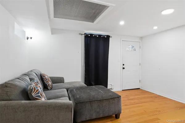 a living room with a couch and a walk in closet