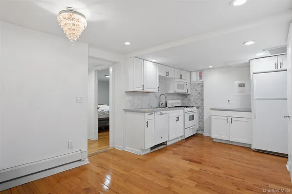 a kitchen with a refrigerator a sink and cabinets