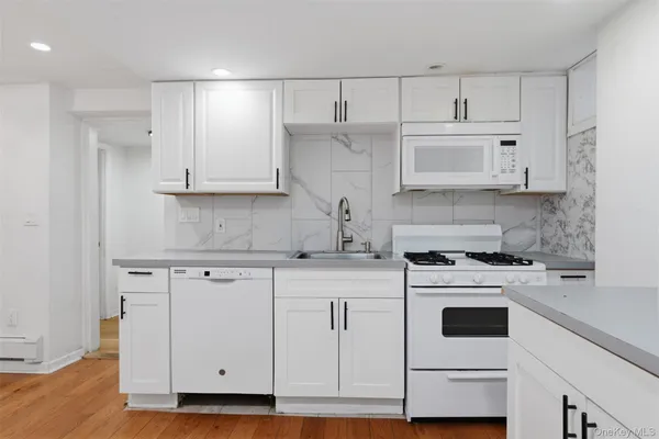 a kitchen with cabinets appliances and a sink