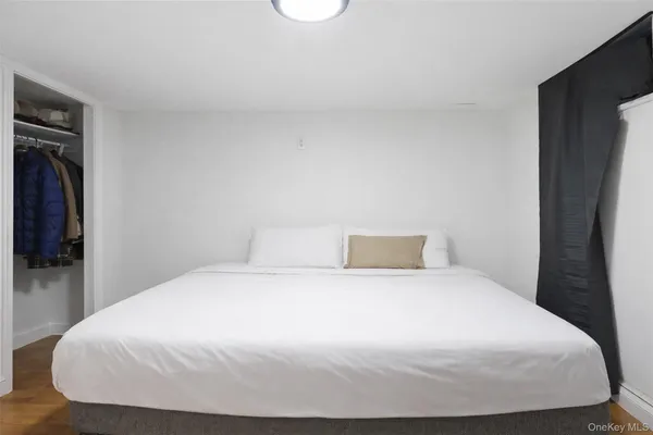 a large bed sitting in a bedroom and a mirror