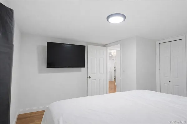 a bedroom with a bed and a flat screen tv