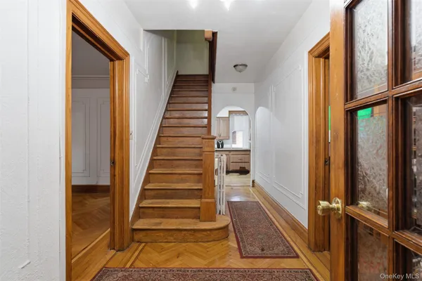 a view of entryway with wooden floor and door