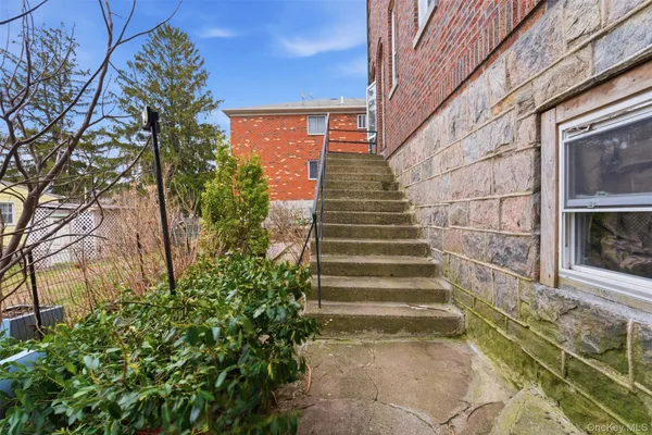a view of a brick house with a yard
