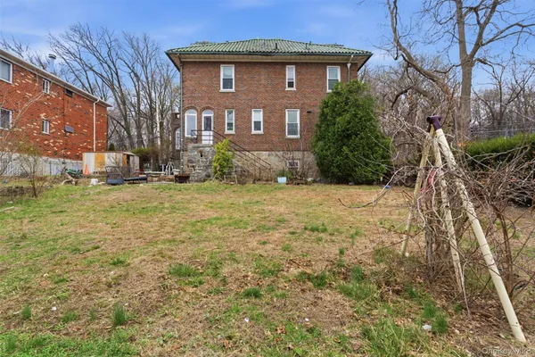 a view of a big house with a yard