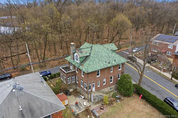 an aerial view of multiple houses with a yard