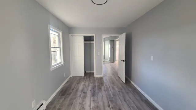 wooden floor in an empty room with a window