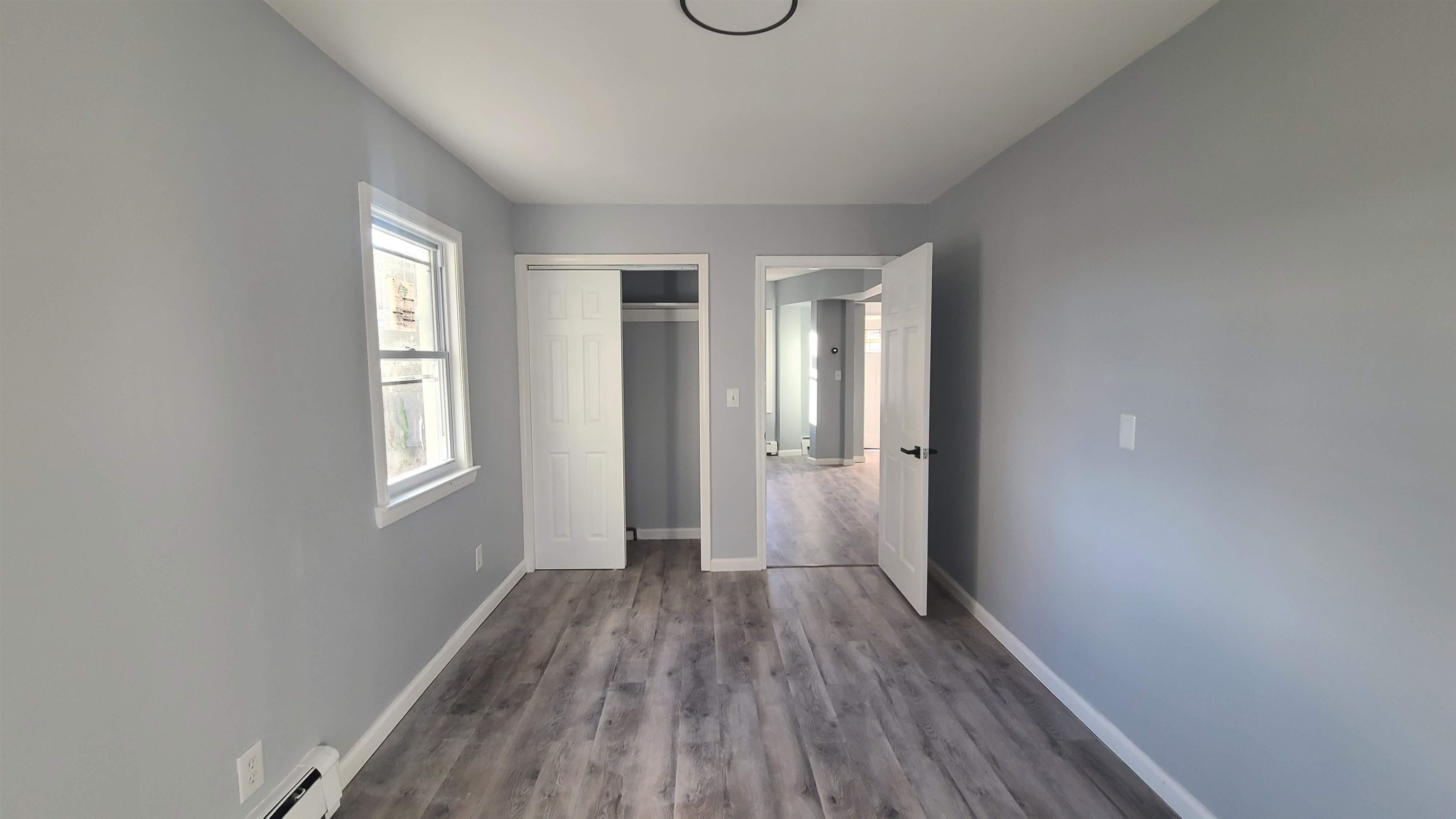 6206 Newkirk Avenue, Unit 1 North Bergen, NJ 07047 - Photo 11 of 20 wooden floor in an empty room with a window