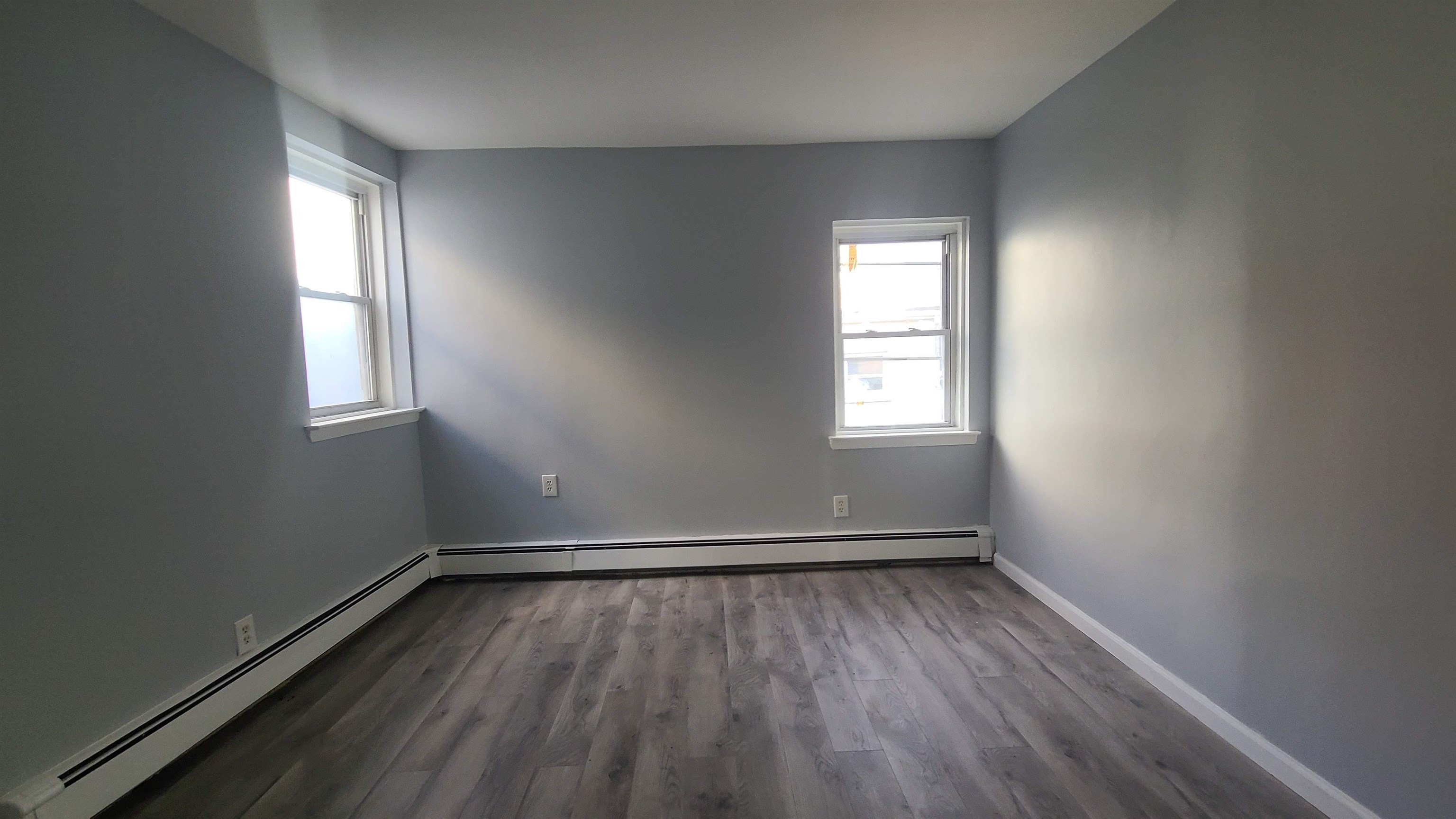 6206 Newkirk Avenue, Unit 1 North Bergen, NJ 07047 - Photo 12 of 20 an empty room with wooden floor and windows