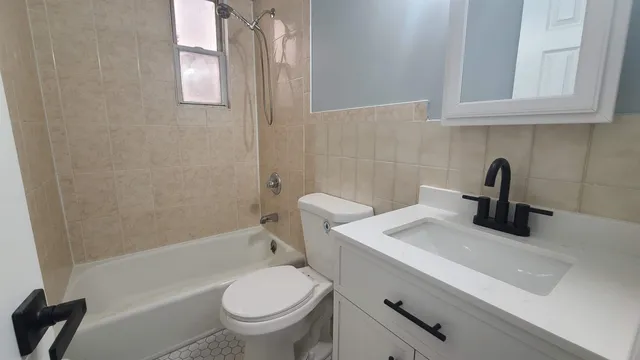 a bathroom with a sink a toilet and bathtub
