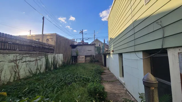 a view of a house with a backyard
