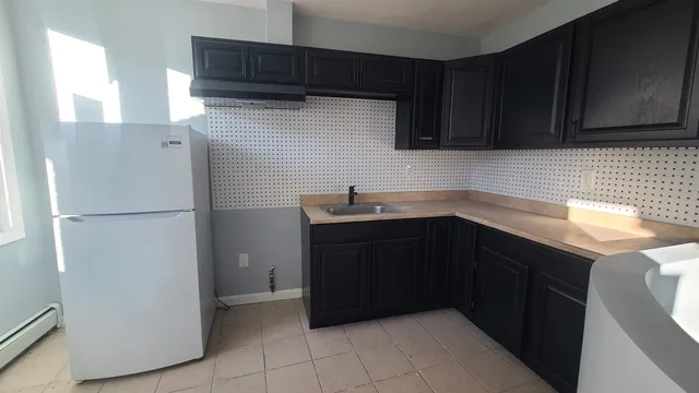 a kitchen with a refrigerator and cabinets