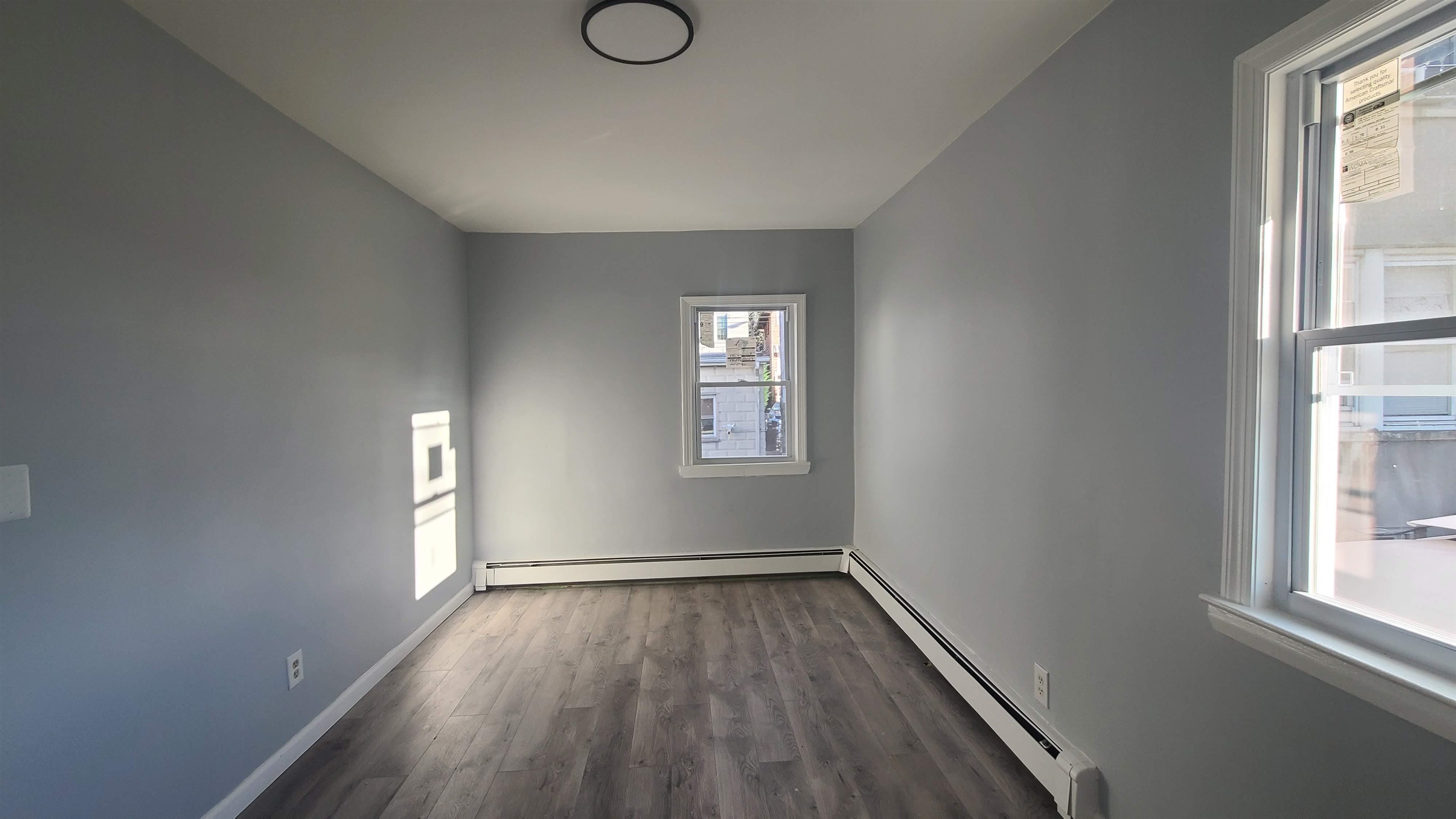 6206 Newkirk Avenue, Unit 1 North Bergen, NJ 07047 - Photo 5 of 20 an empty room with wooden floor and windows