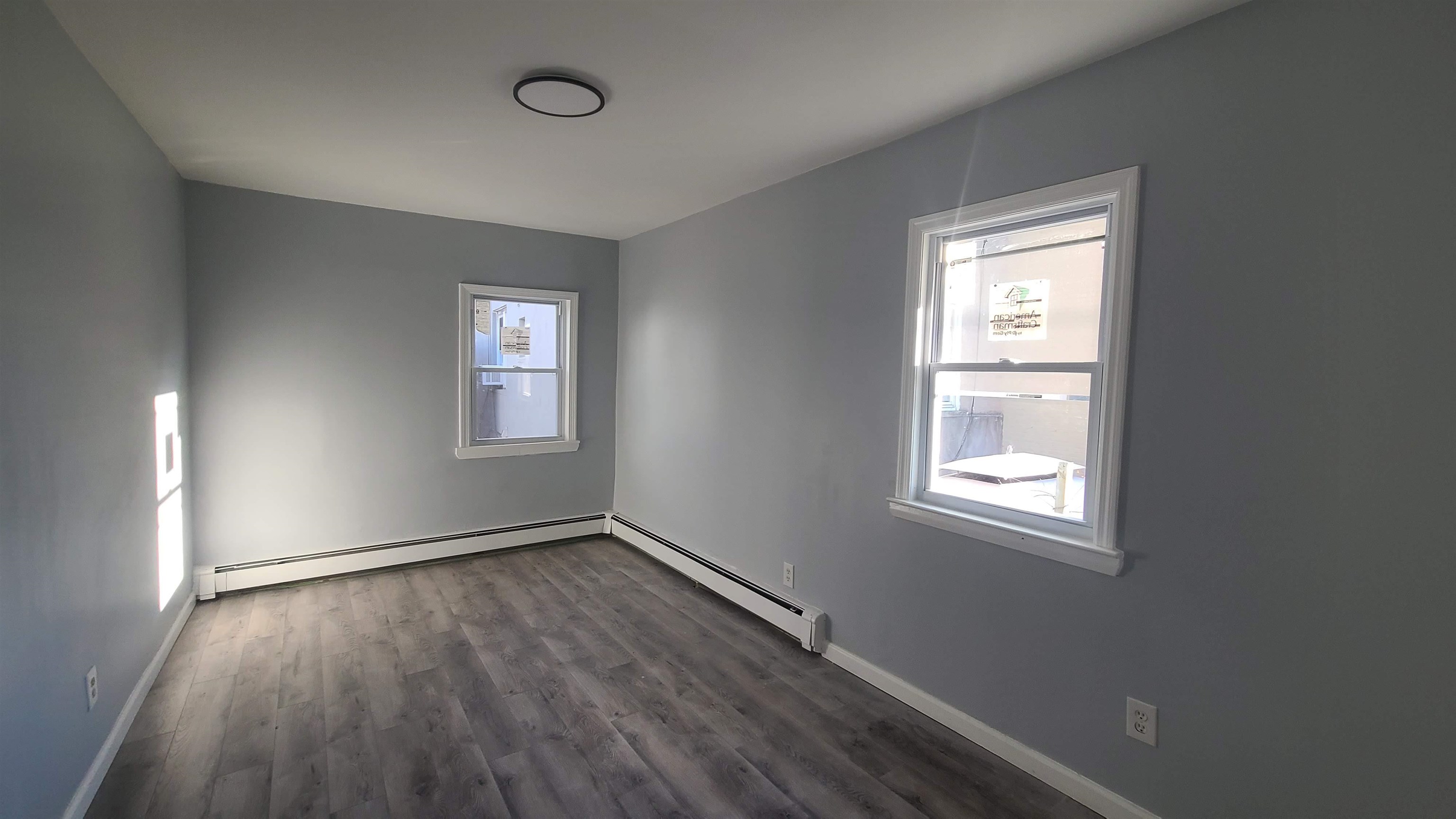 6206 Newkirk Avenue, Unit 1 North Bergen, NJ 07047 - Photo 6 of 20 an empty room with wooden floor and windows