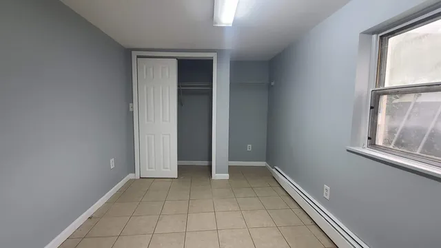 an empty room with windows and entrance