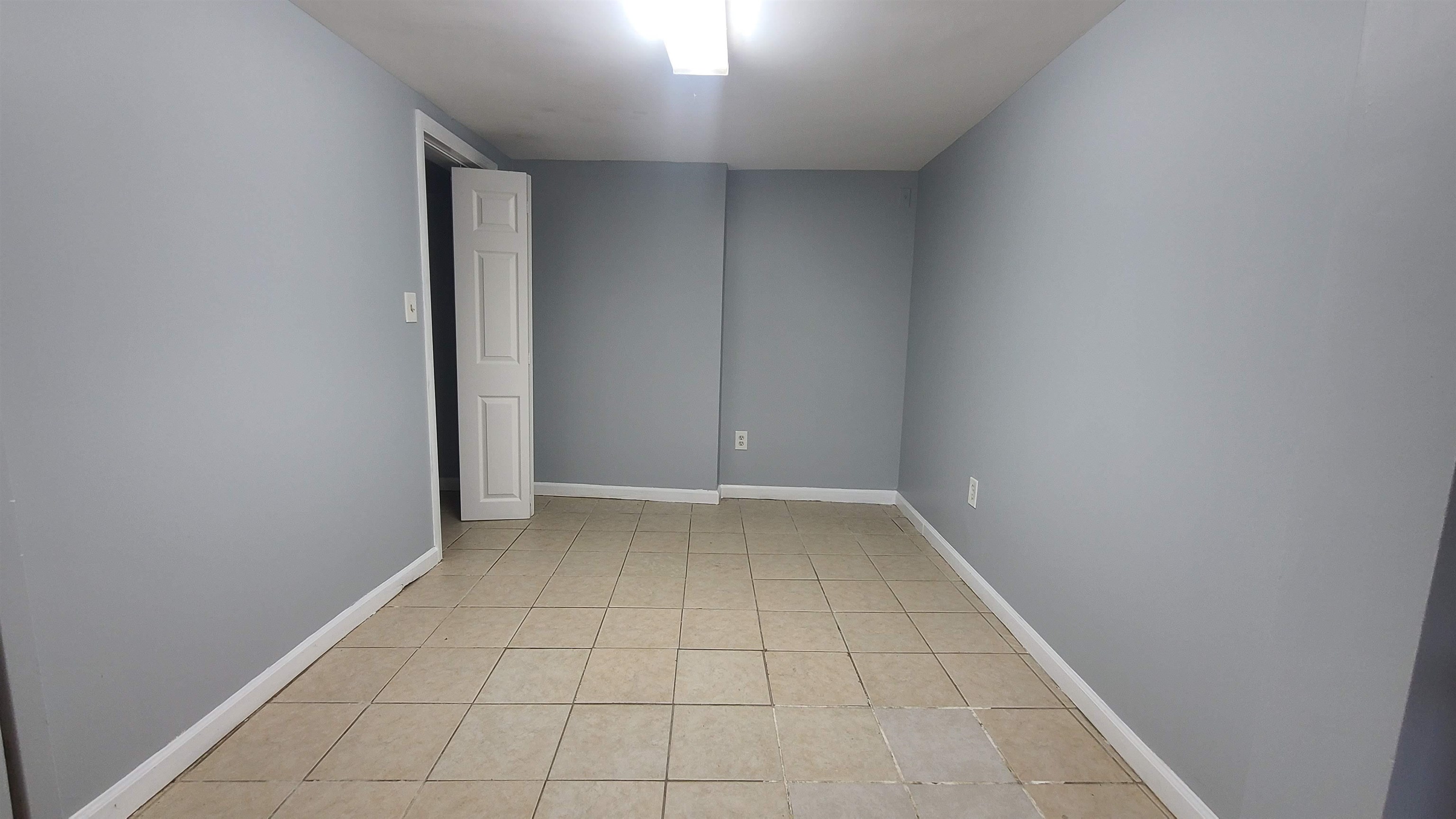 6206 Newkirk Avenue, Unit 1 North Bergen, NJ 07047 - Photo 9 of 20 an empty room with white walls and tiles